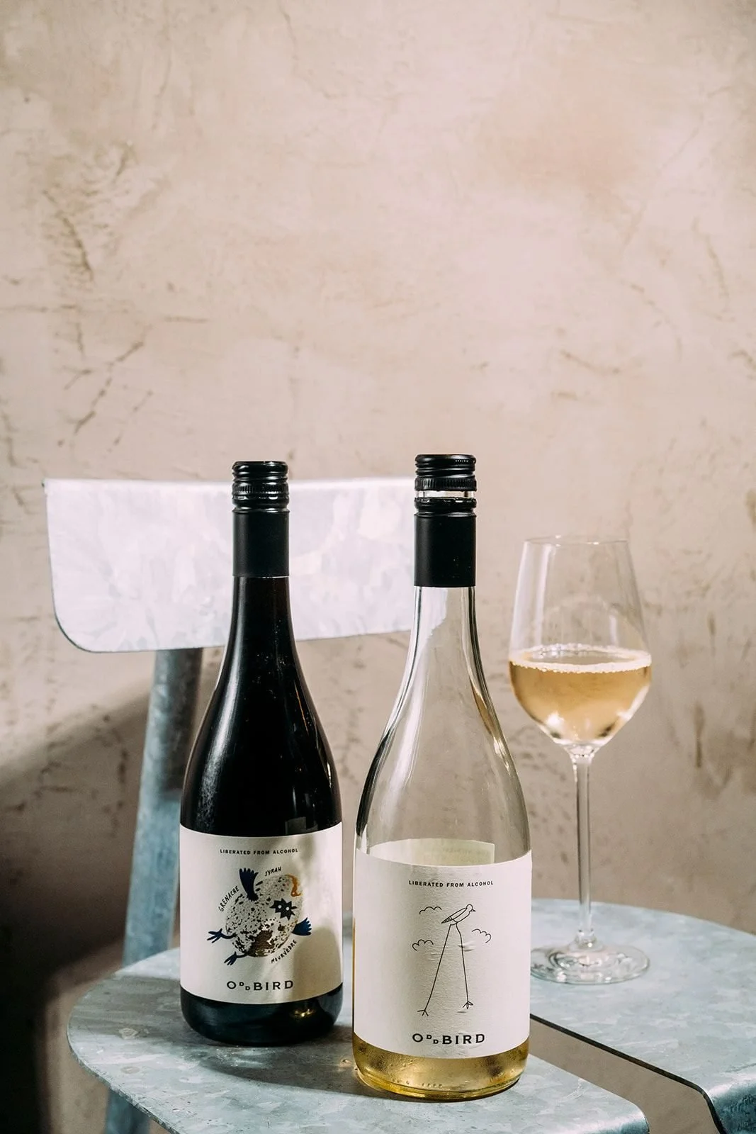 Bottles of natural wine against the plaster wall at Win