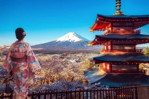 Mount Fuji rising behind a red five-story pagoda