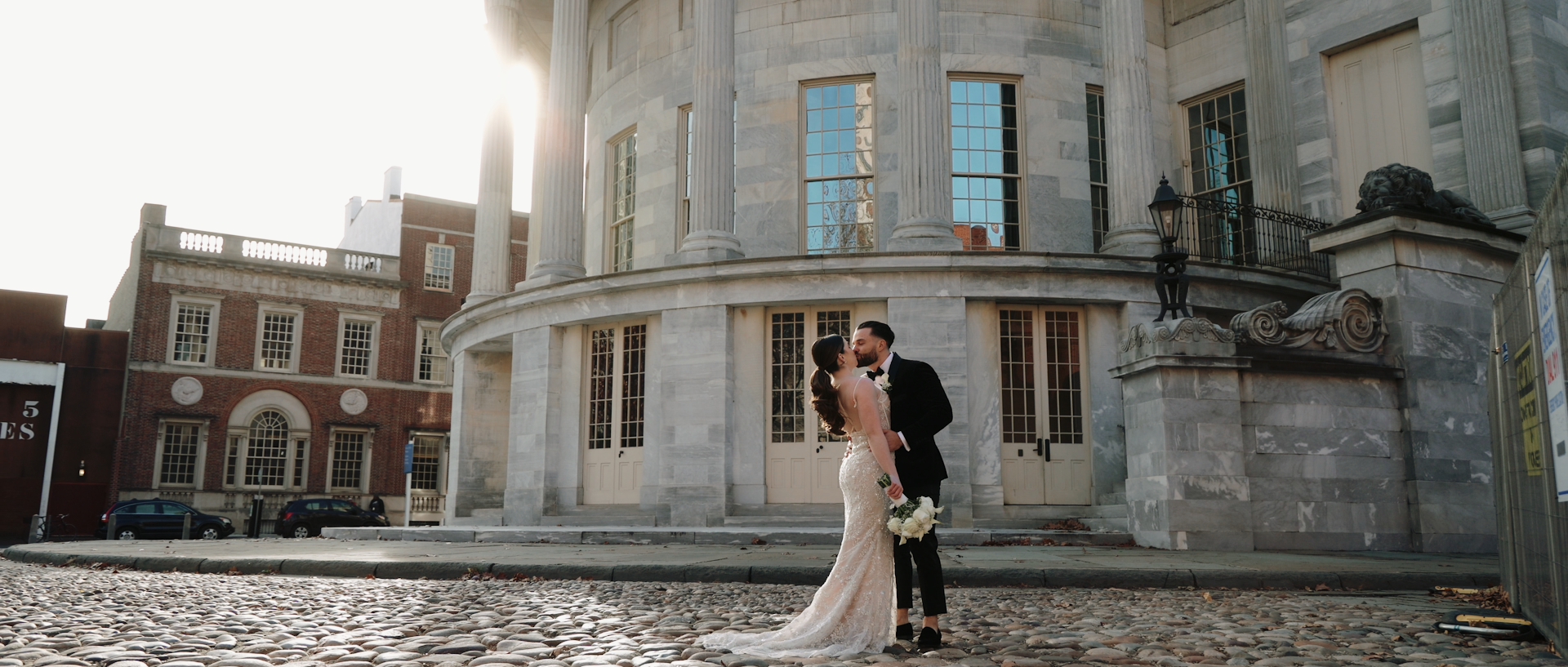 Newlyweds standing outside a grand city venue