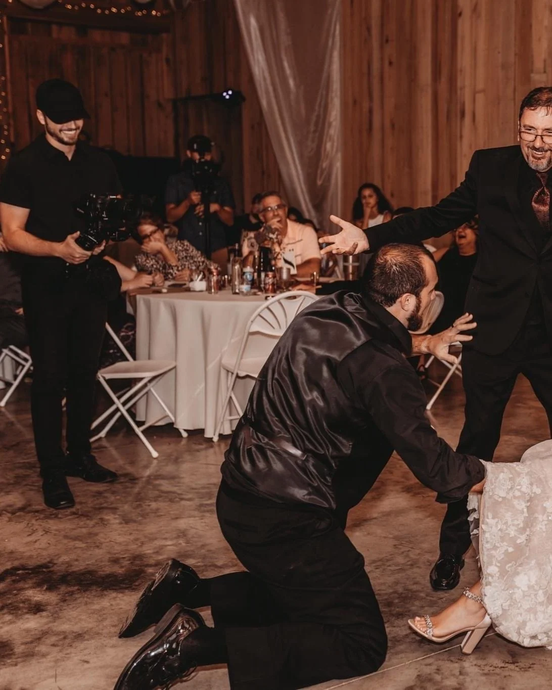 Alex filming an emotional wedding reception moment