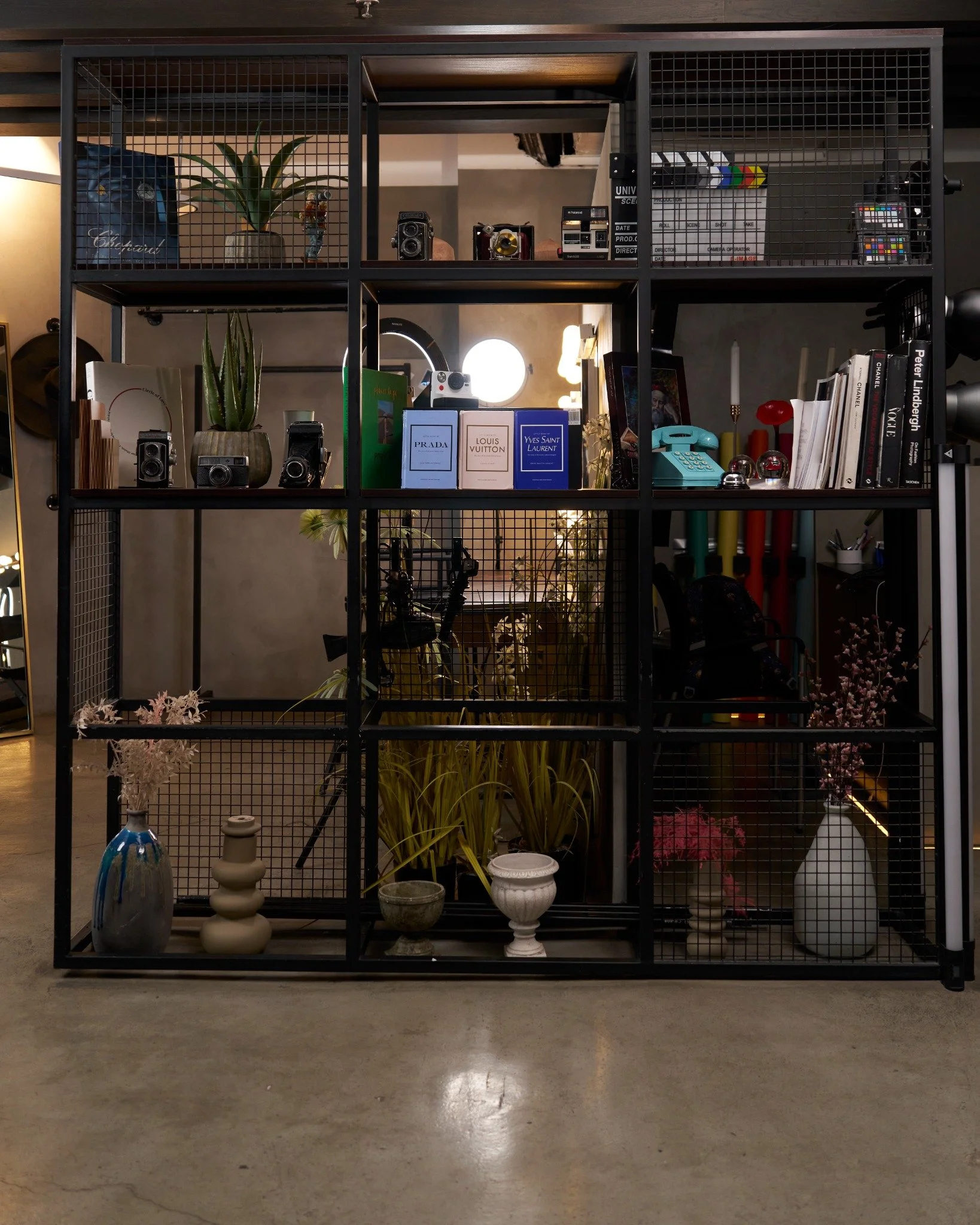 The display cabinet: photography books, vintage cameras and collected objects