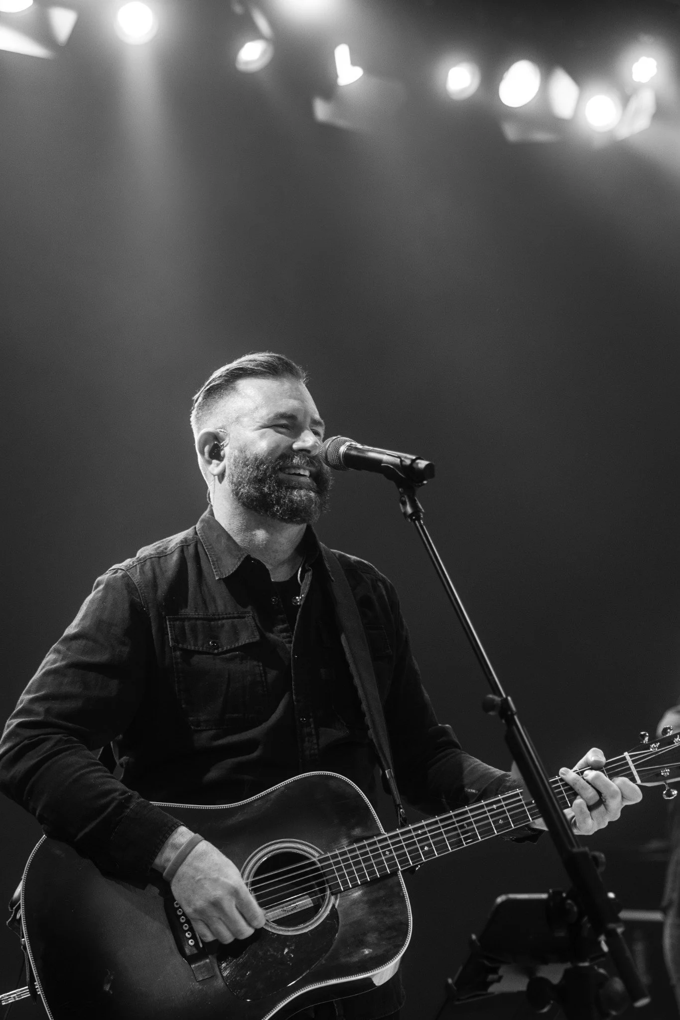 Josh Smith leading worship with an acoustic guitar