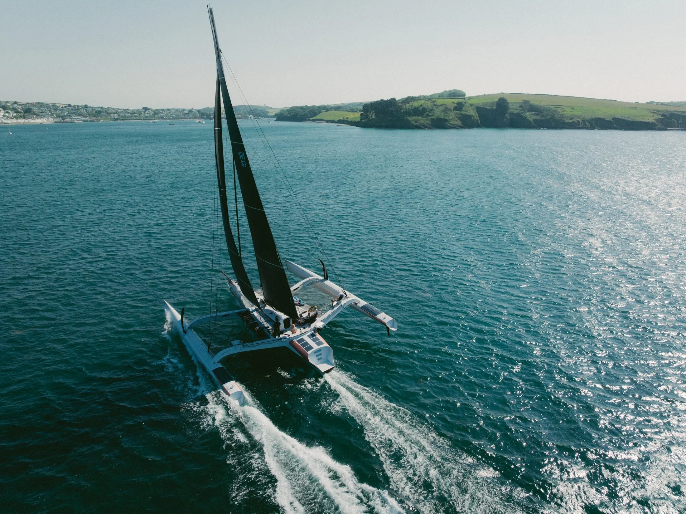 Aerial of the trimaran Paradox sailing off Cornwall, filmed with a DJI Mavic drone