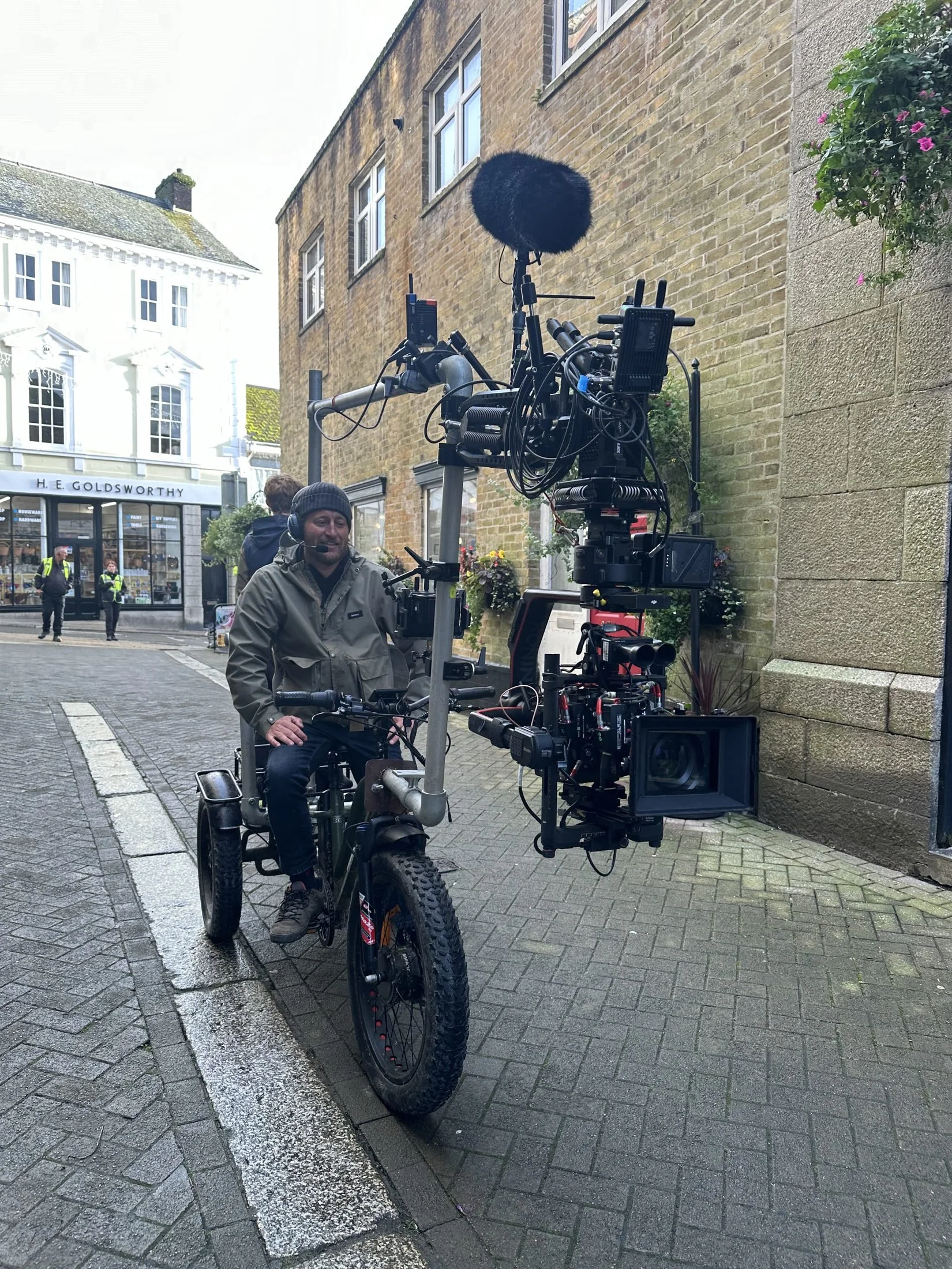 Cine-trike with a heavy camera rig tracking along a town street