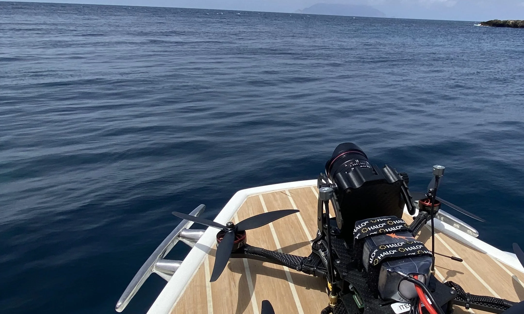 FPV drone with a cinema camera on the bow of a boat at sea