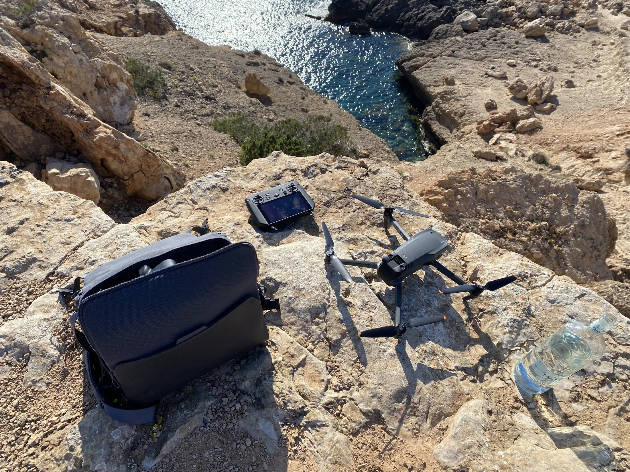 DJI Mavic 3 set up on rocks above a cove on location