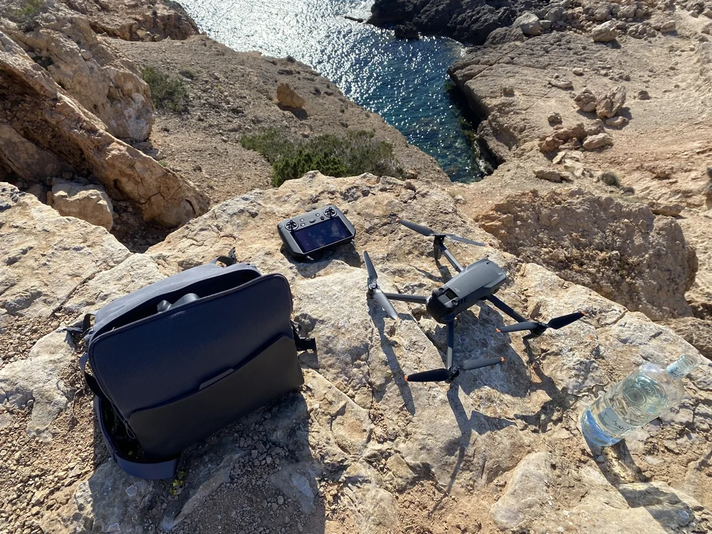 DJI Mavic 3 Pro Cine set up on rocks above a cove on location