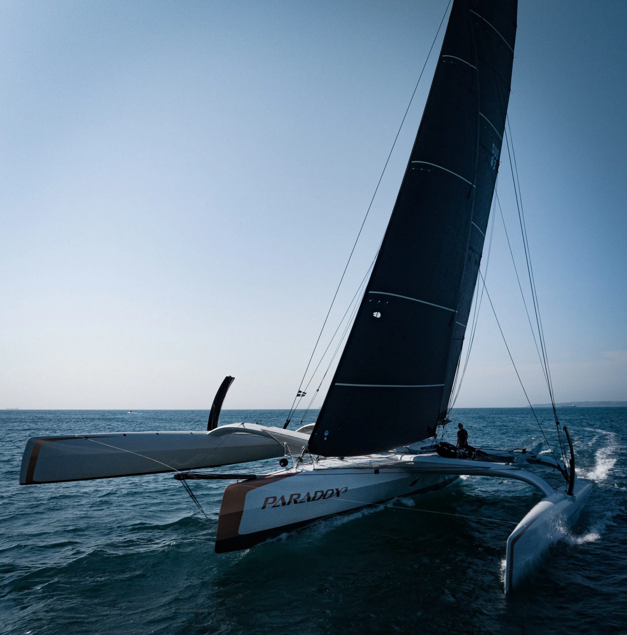 Low-angle shot of the trimaran Paradox under sail, filmed with a DJI Mavic 3