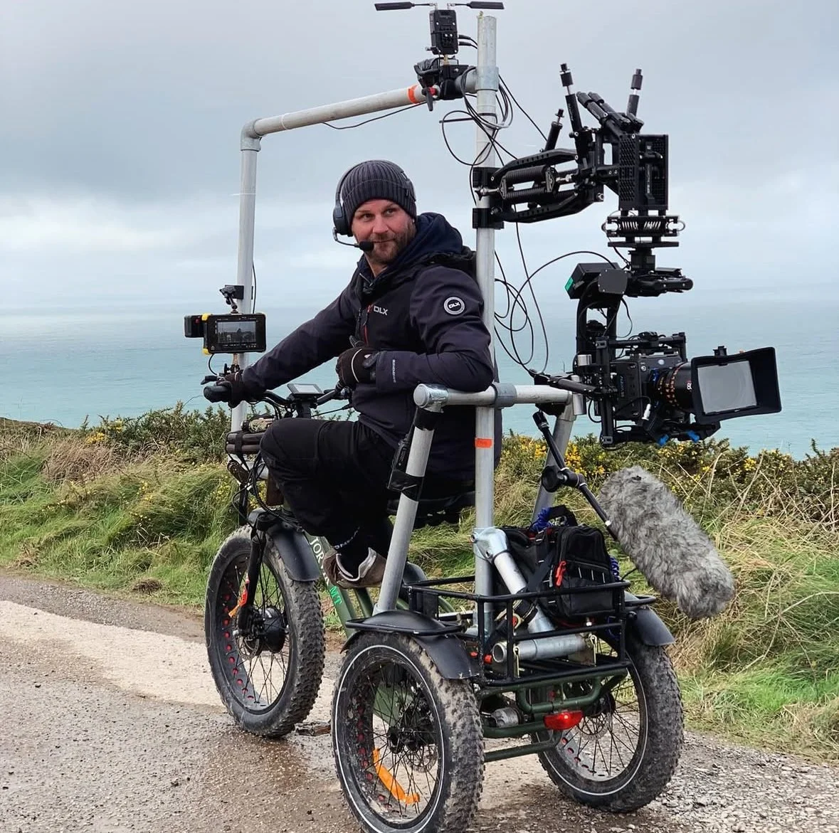 Electric cine-trike with a cinema camera on a gimbal on a Cornish clifftop