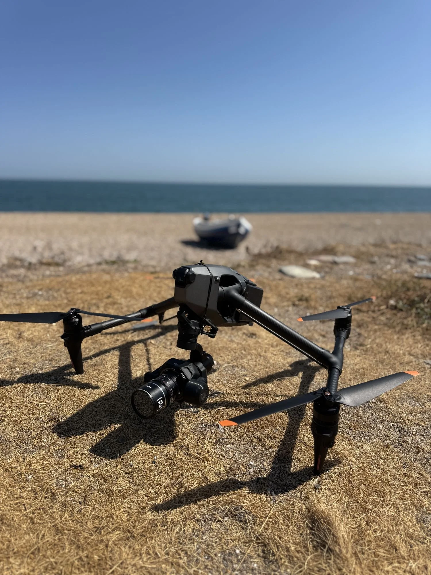 DJI Inspire 3 with Zenmuse X9-8K camera and lens, landed on a beach ready to fly