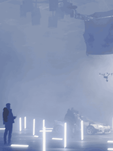 Cine-trike tracking through haze and light bars on a stage