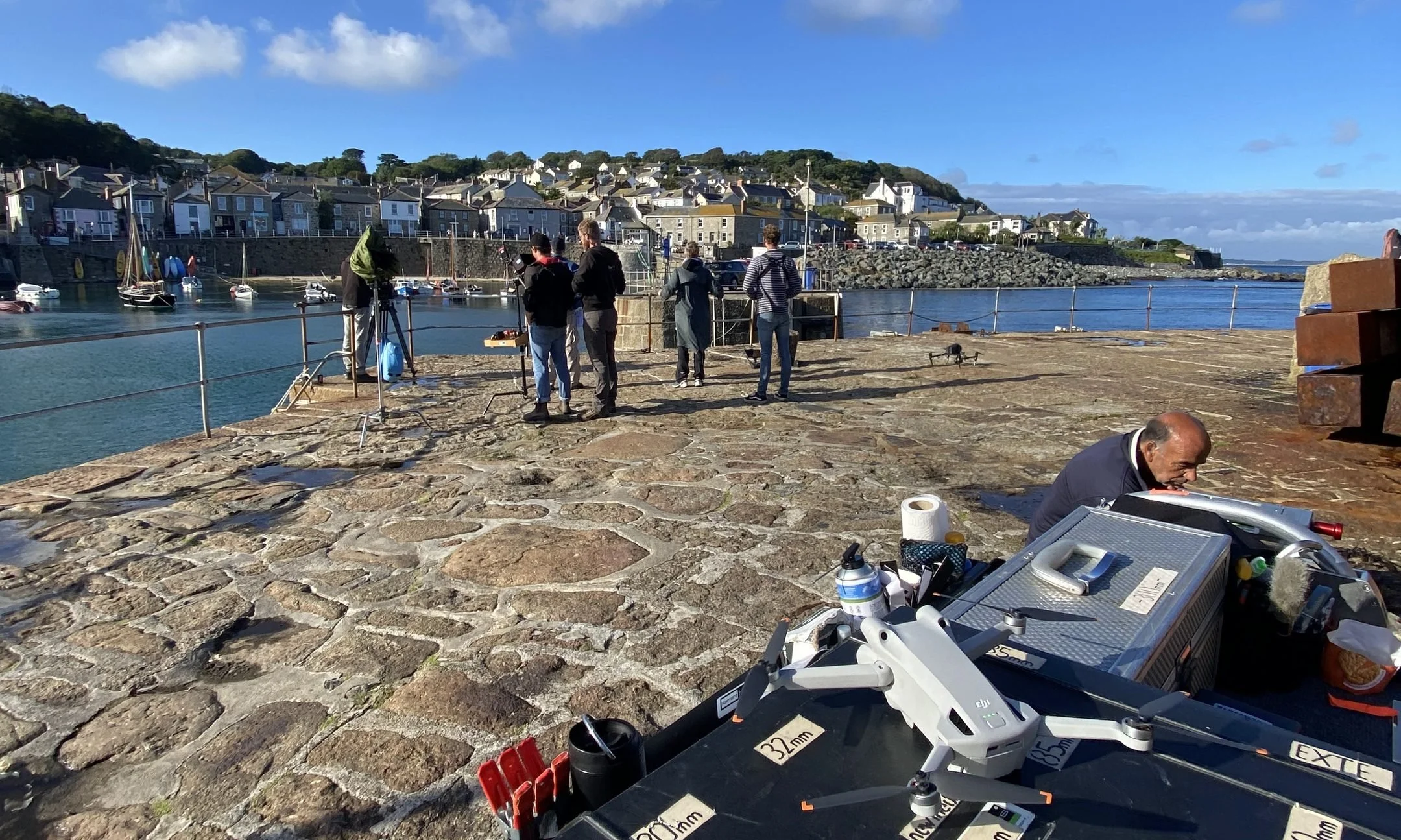 Sub-250g DJI Mini drone ready to fly on a harbour film set in Cornwall