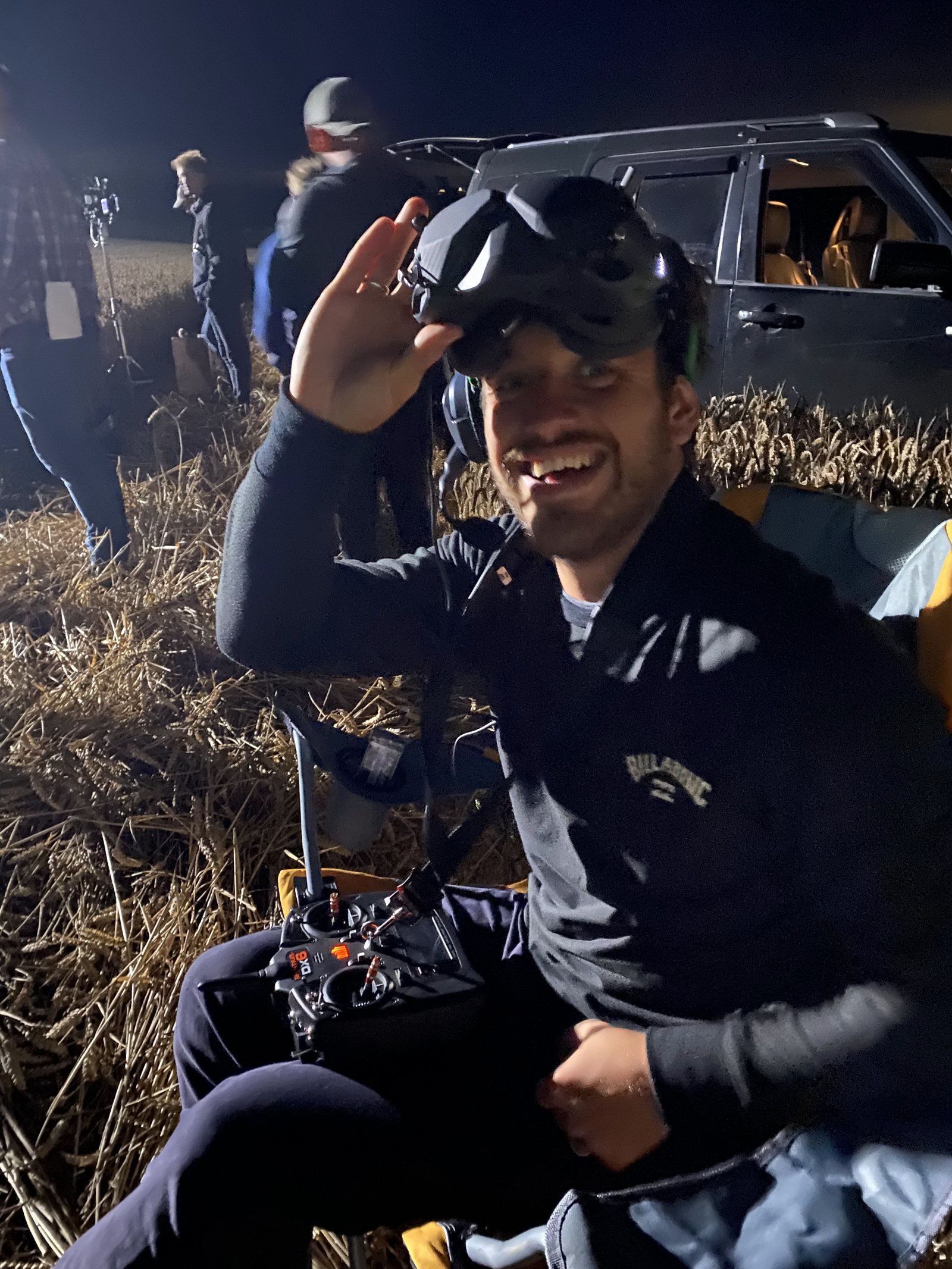 FPV pilot in goggles on a night shoot with the FPV light drone