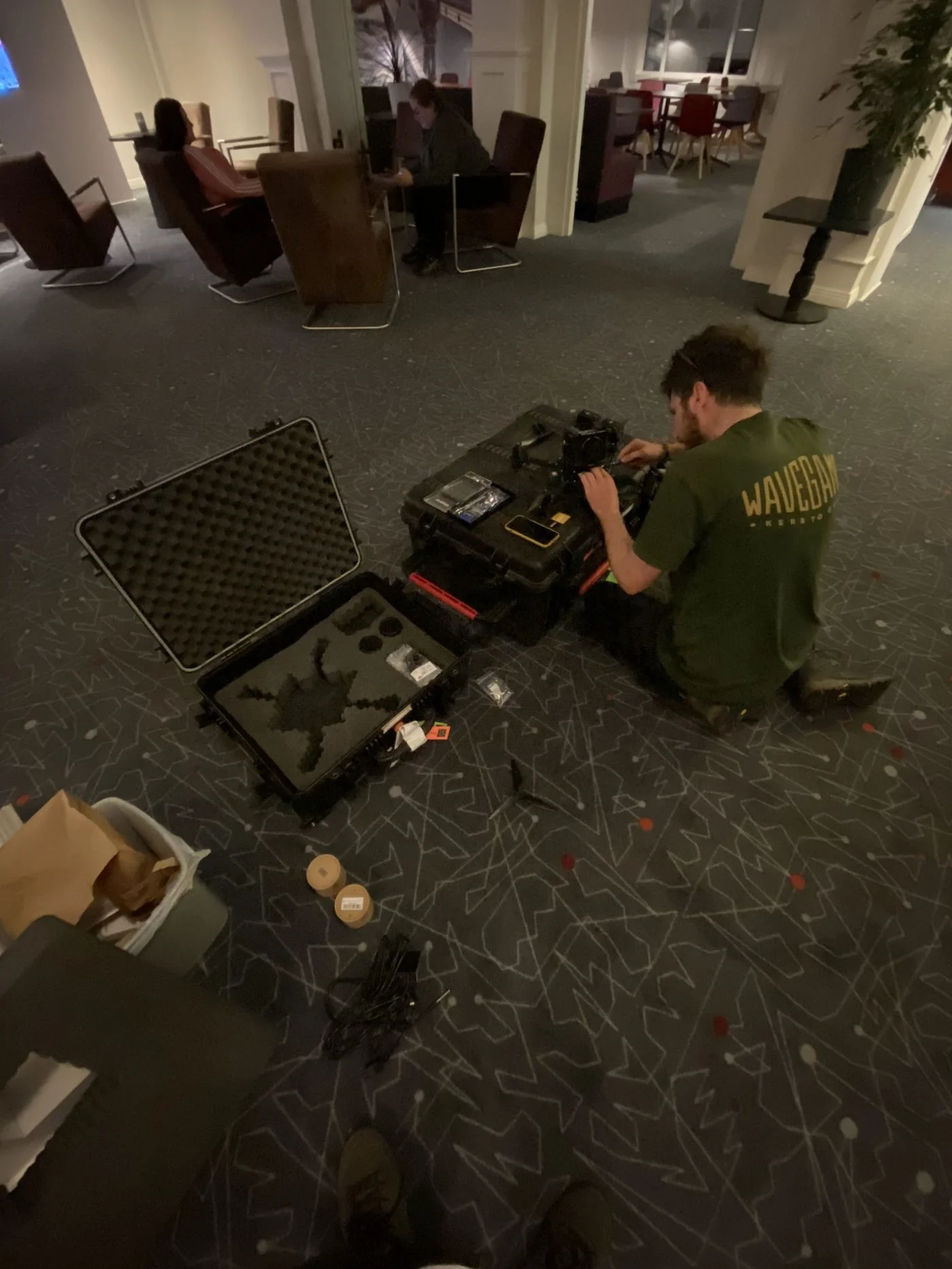 Crew preparing an FPV drone inside a venue