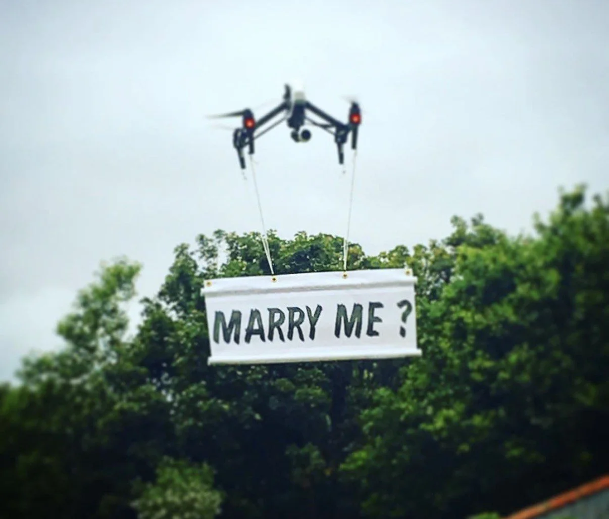 Drone flying a Marry me banner above the trees for a TV drama scene