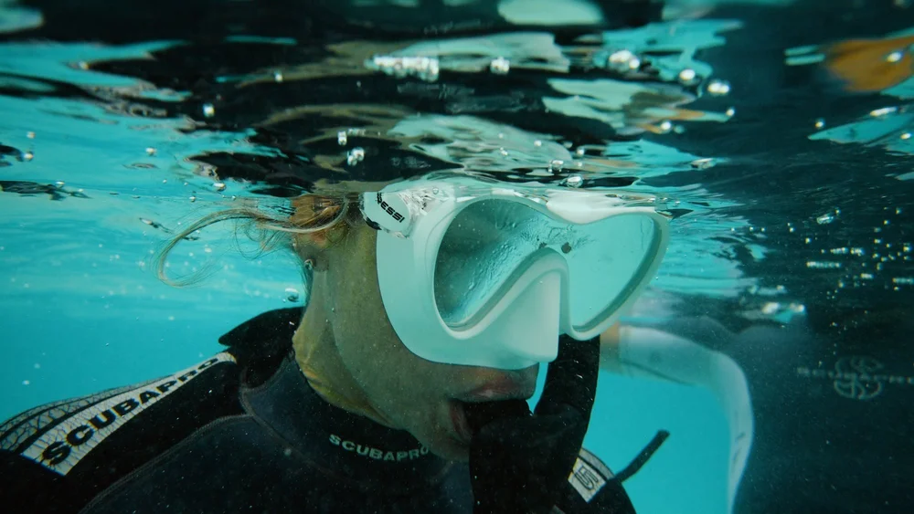 Close-up of a freediver in a mask underwater