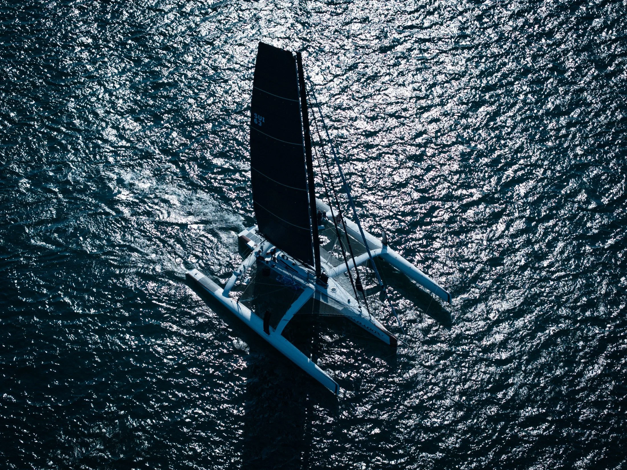 Top-down aerial of a trimaran, filmed with a DJI Mavic