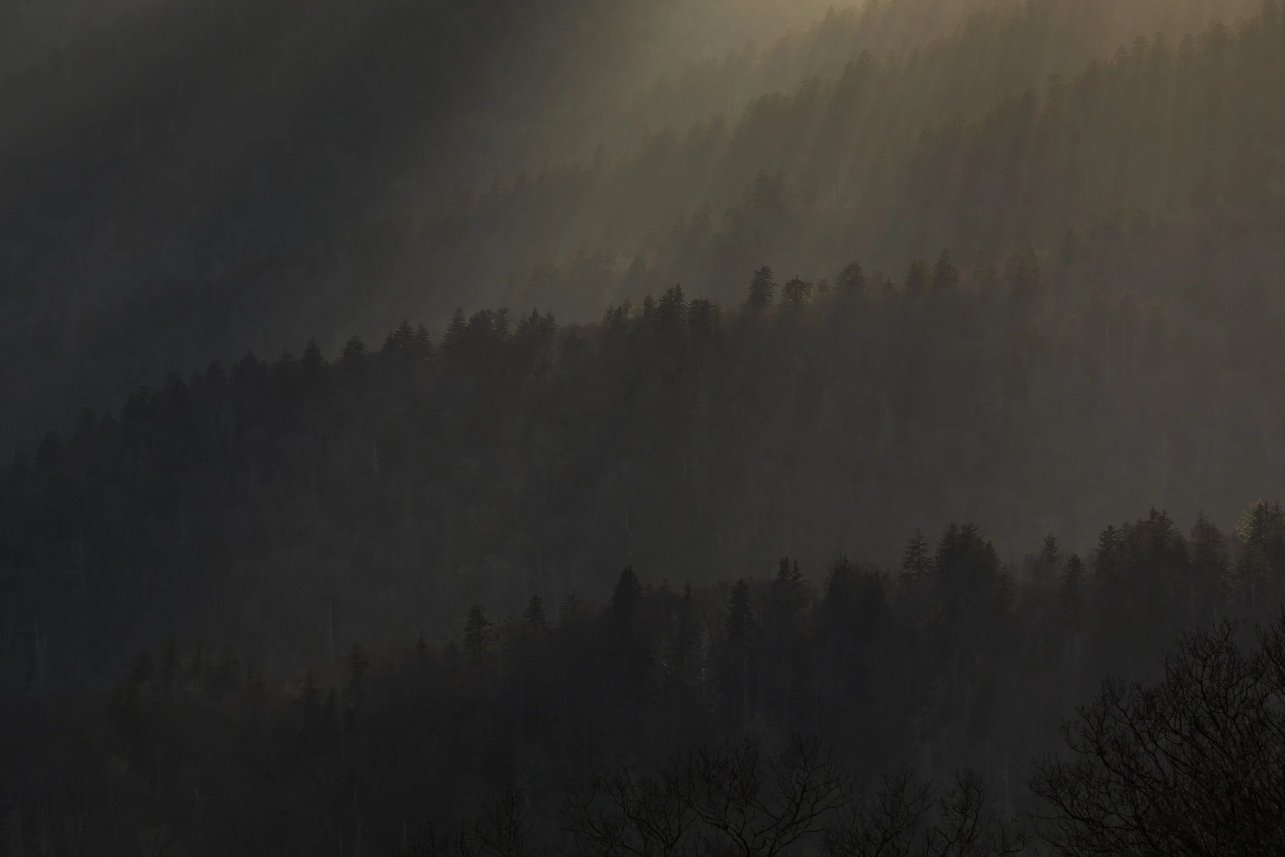 Layered mountain landscape under atmospheric skies; illustrative placeholder photograph