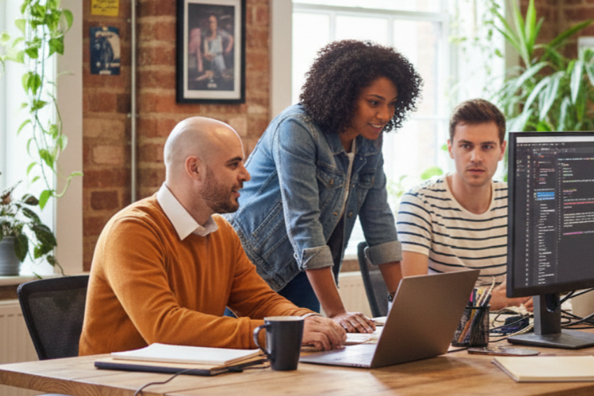Team members sitting around a conference table discussing business strategy