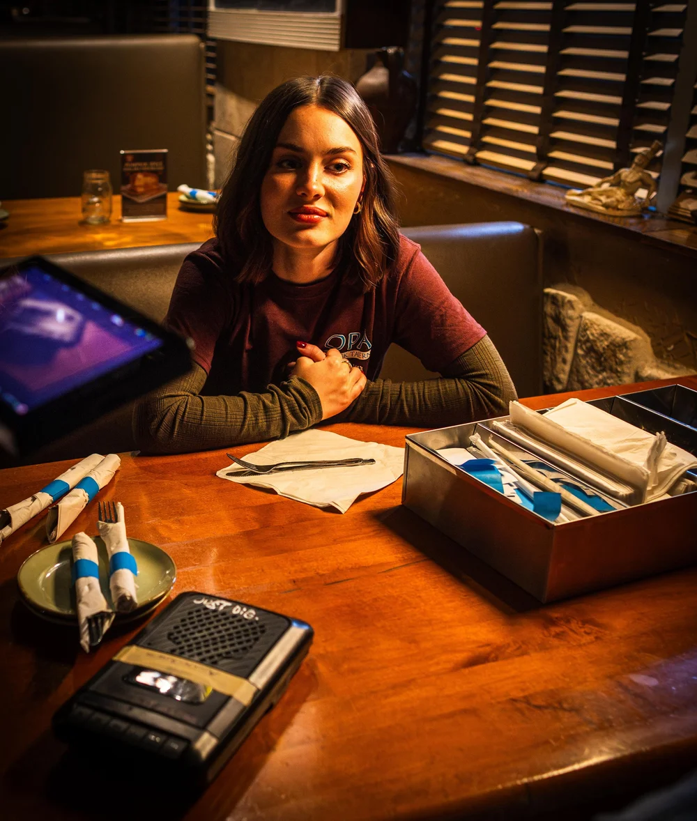 Nicole Alston at the table between takes
