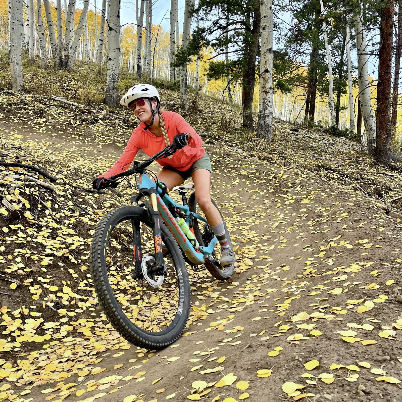 Rider on a mountain bike trail through aspen trees at Devil's Thumb Ranch