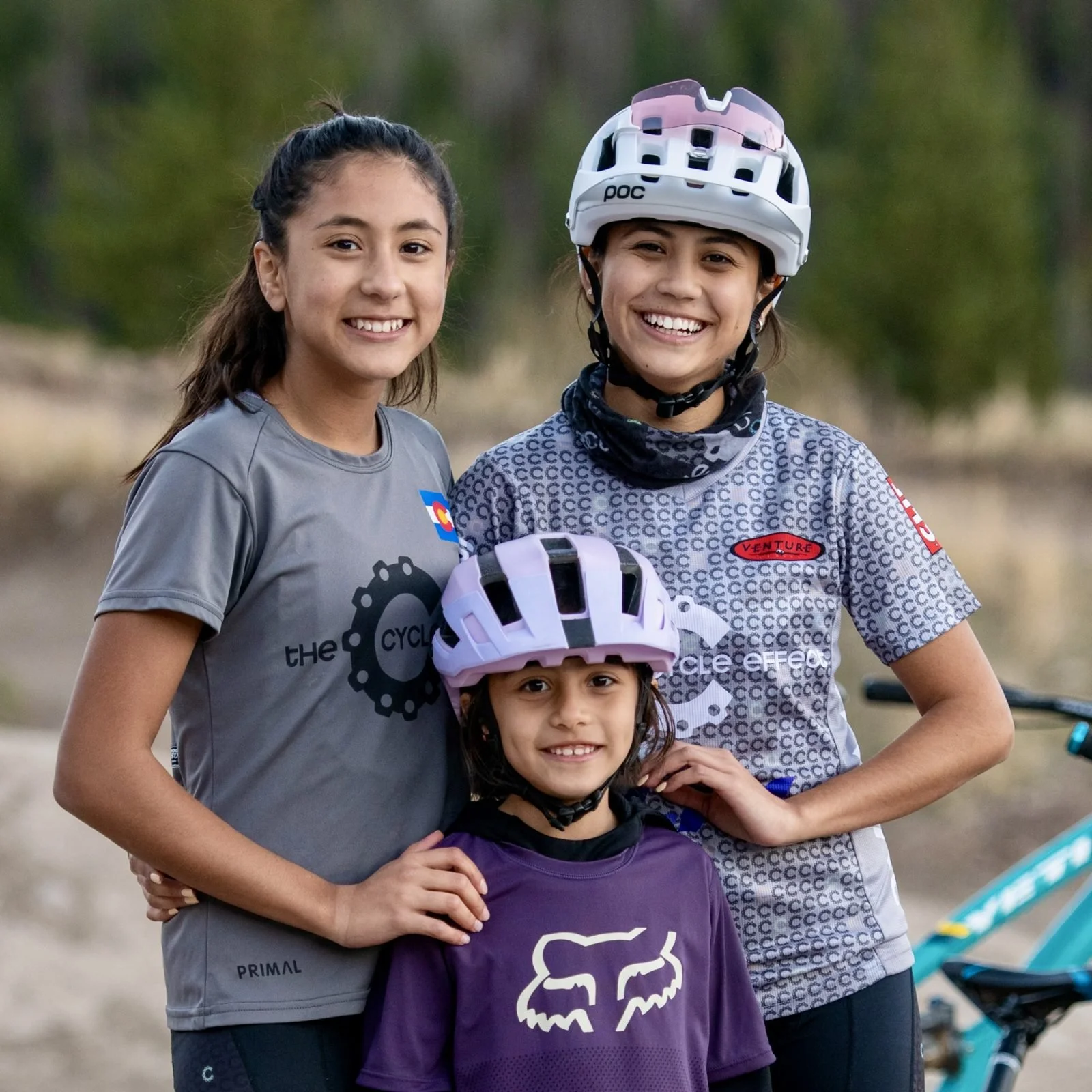 Three Cycle Effect riders smiling together in team gear