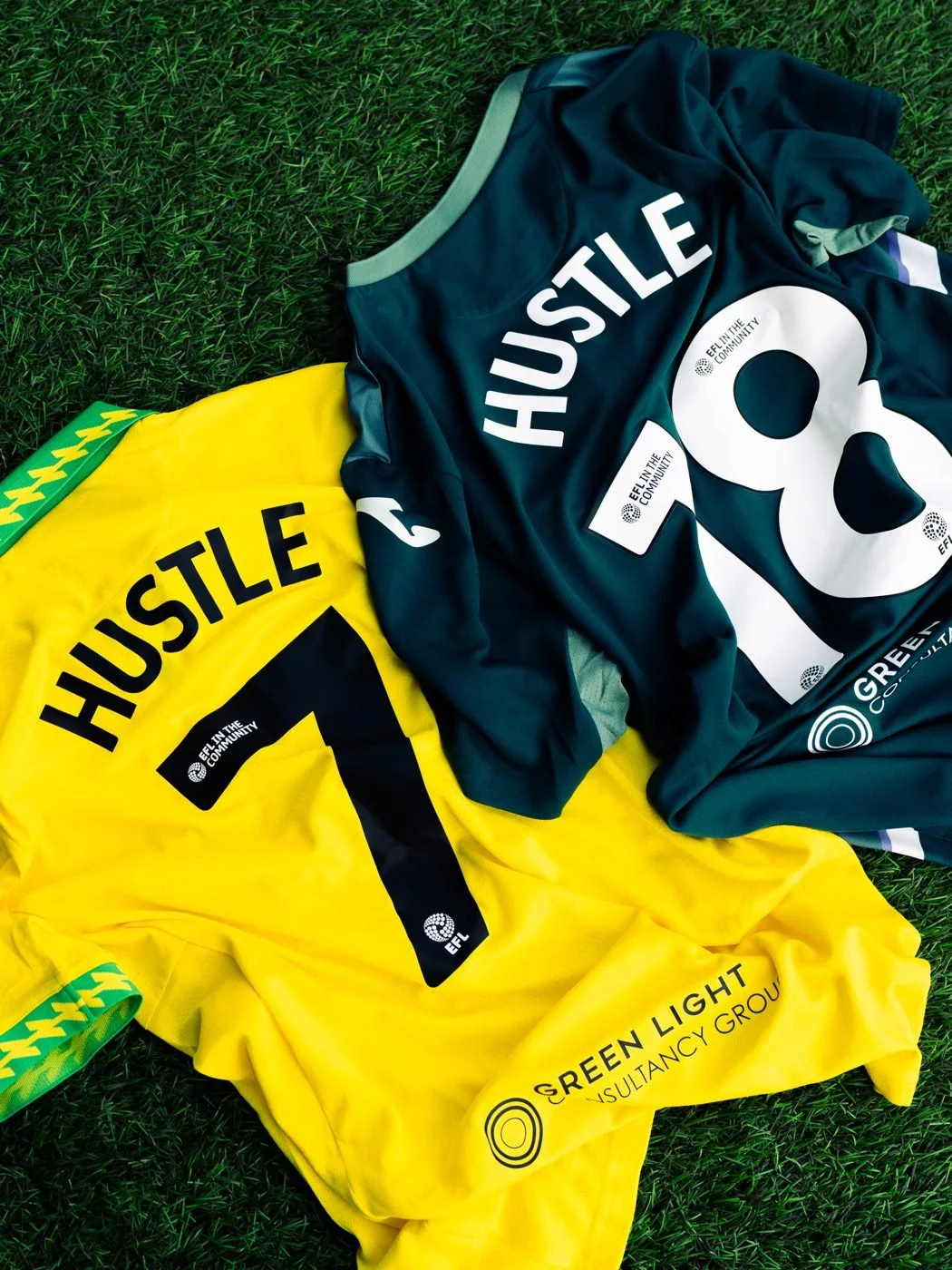 Norwich City home and away shirts printed with HUSTLE