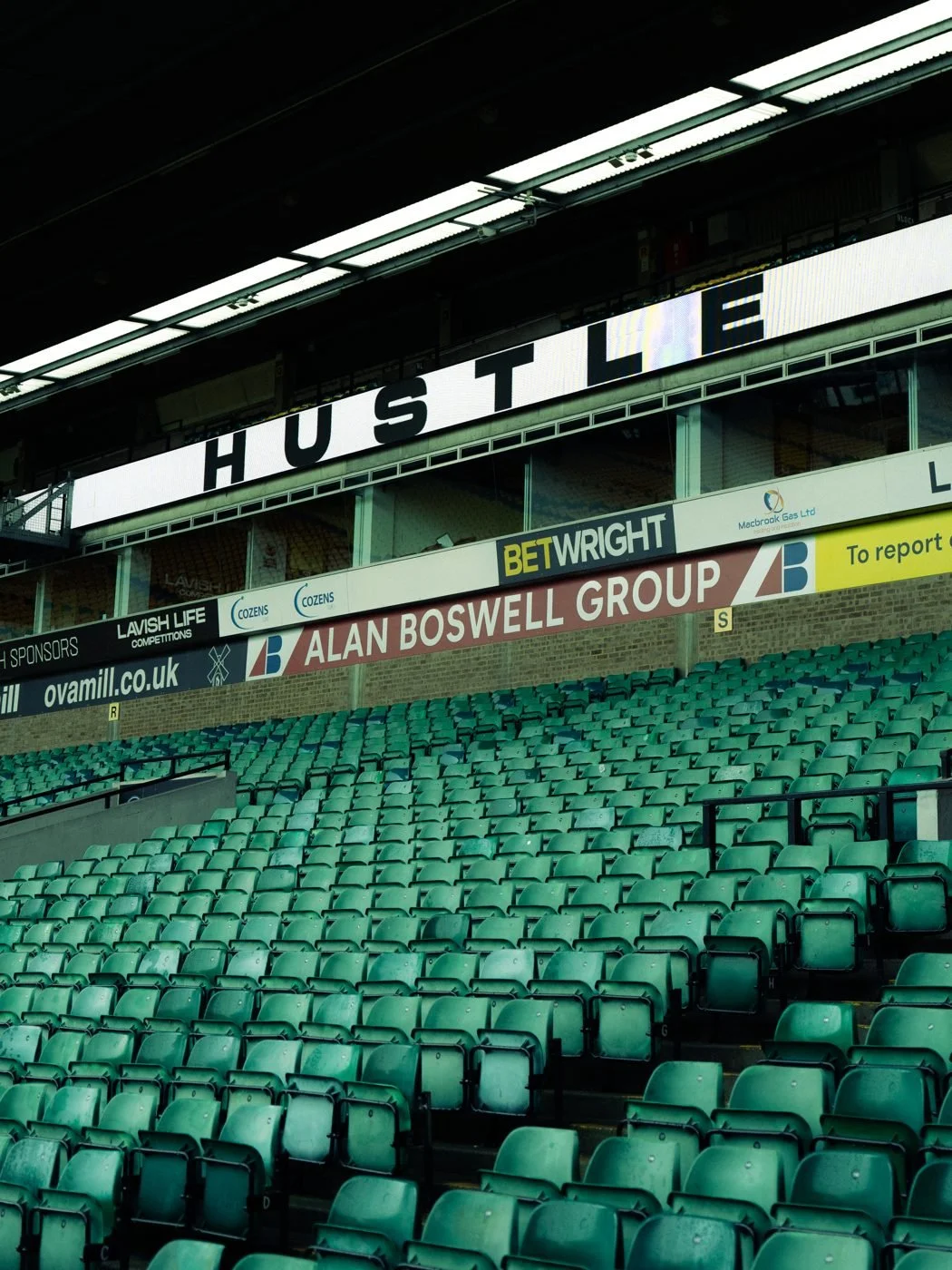 HUSTLE on the LED ribbon above the stands at Carrow Road