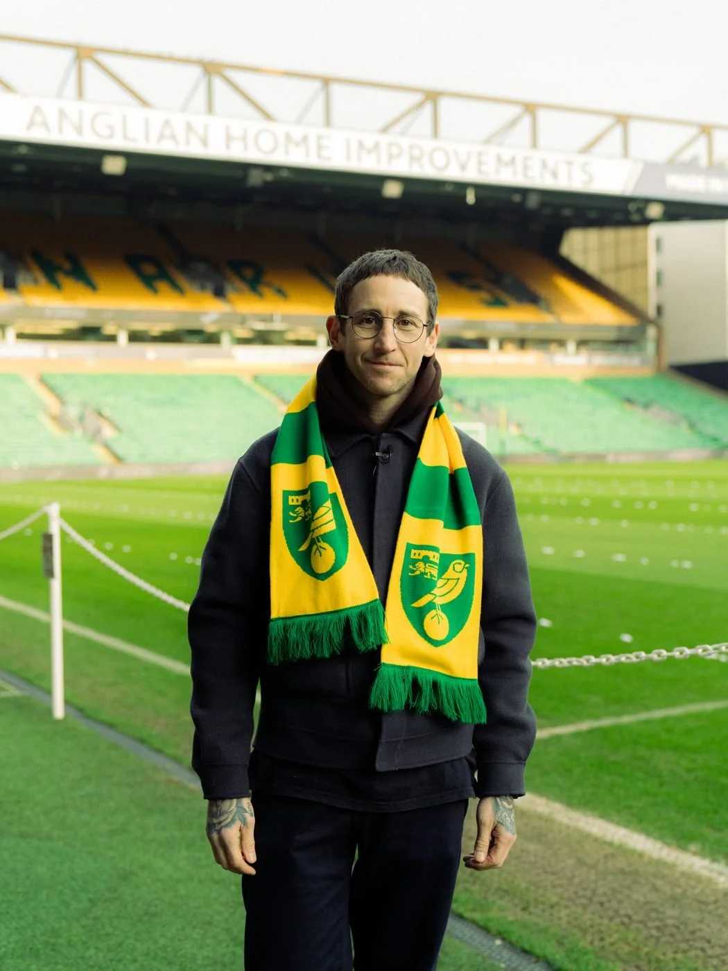 Bobby Harrison, Hustle owner, pitchside at Carrow Road in a Norwich City scarf