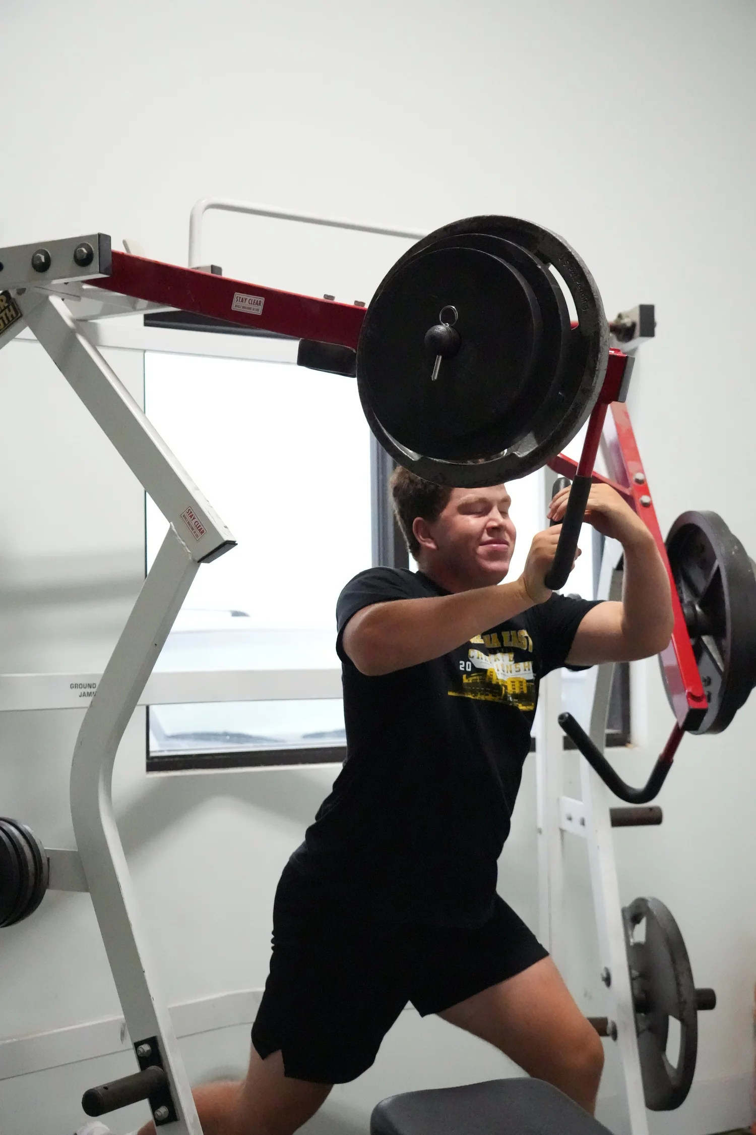 Athlete training on a plate-loaded press machine at the Gretna facility