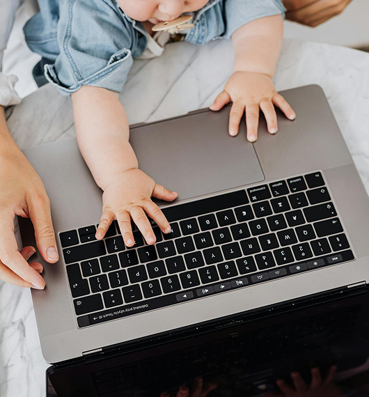 Child typing on laptop