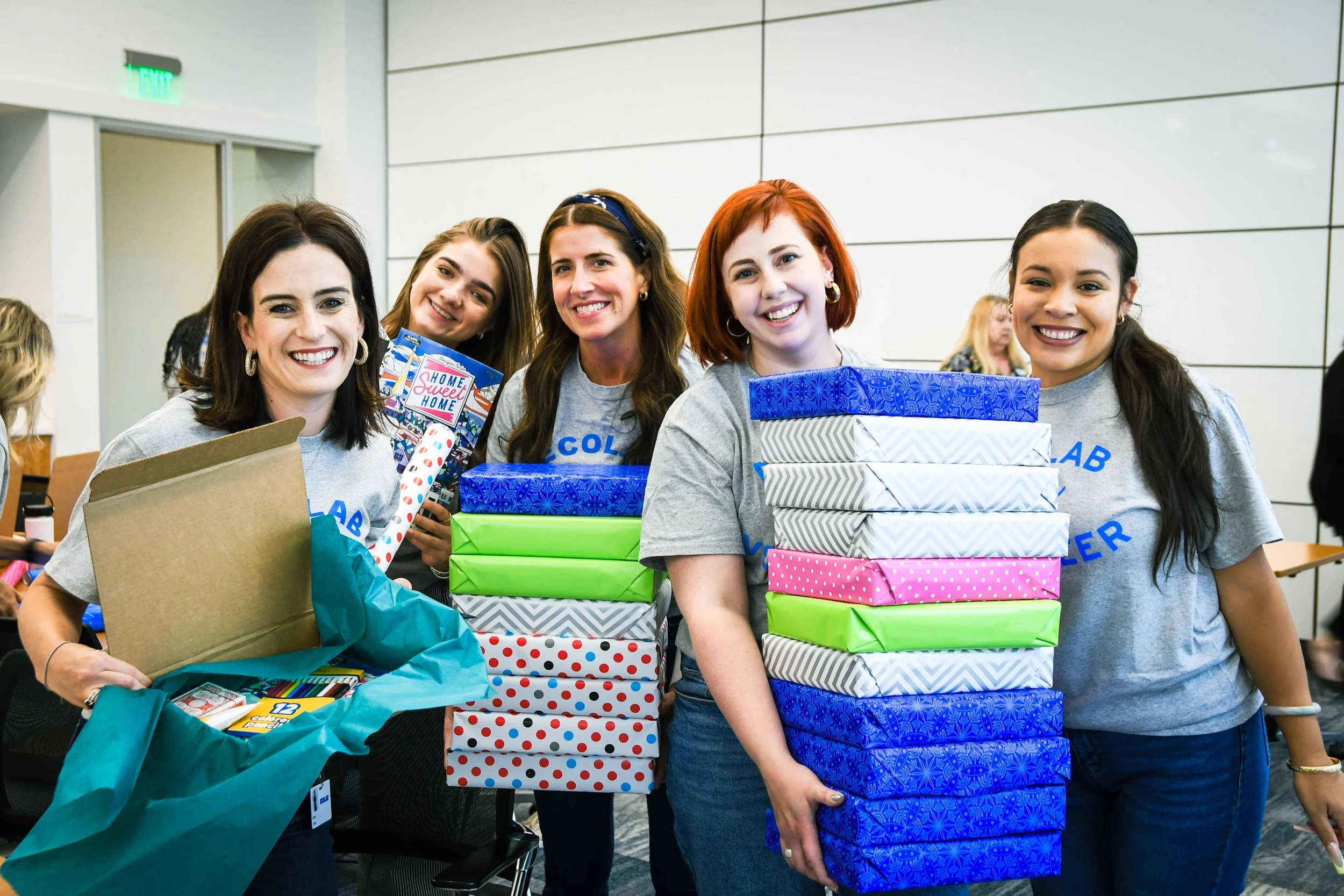 Ecolab volunteers posing with wrapped gifts for seniors