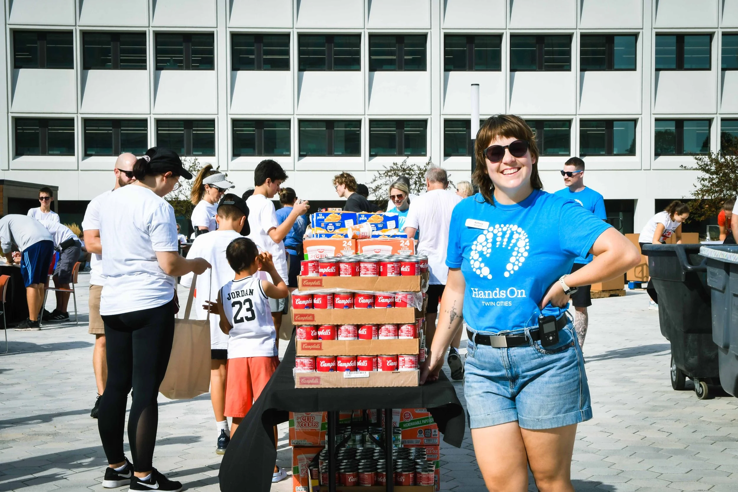 HandsOn Twin Cities staff posing for a picture in front of a big group volunteer project