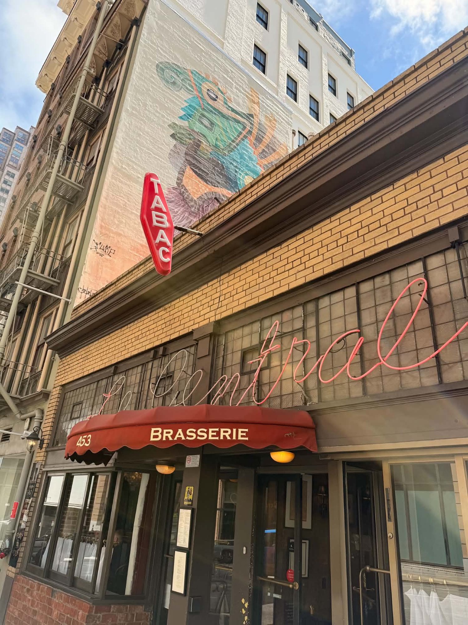 The neon sign and brasserie awning at Le Central on Bush Street in San Francisco