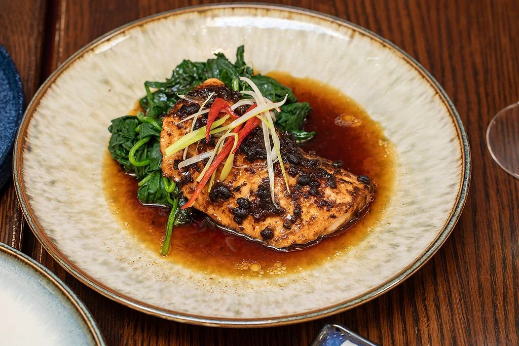 Steamed Kvarøy Arctic salmon with black bean sauce, spinach and scallions
