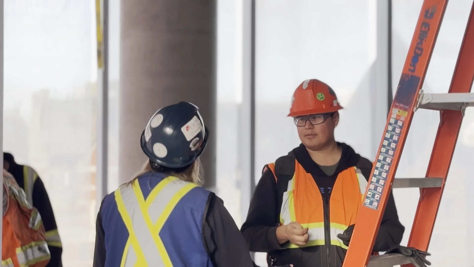 Blue Anvil QA rep with apprentices on the high-rise they helped build