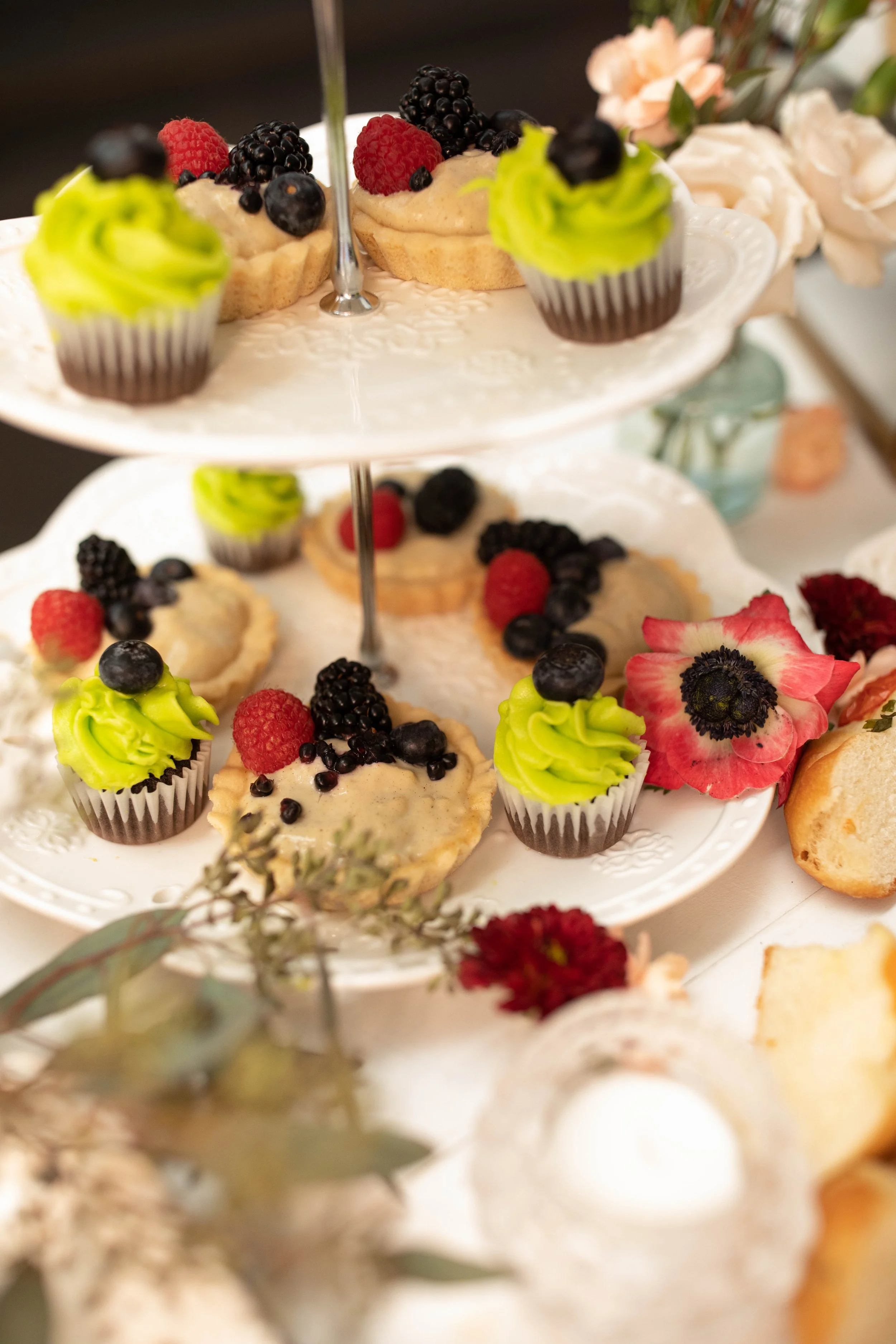 Tiered berry desserts and flowers arranged for service