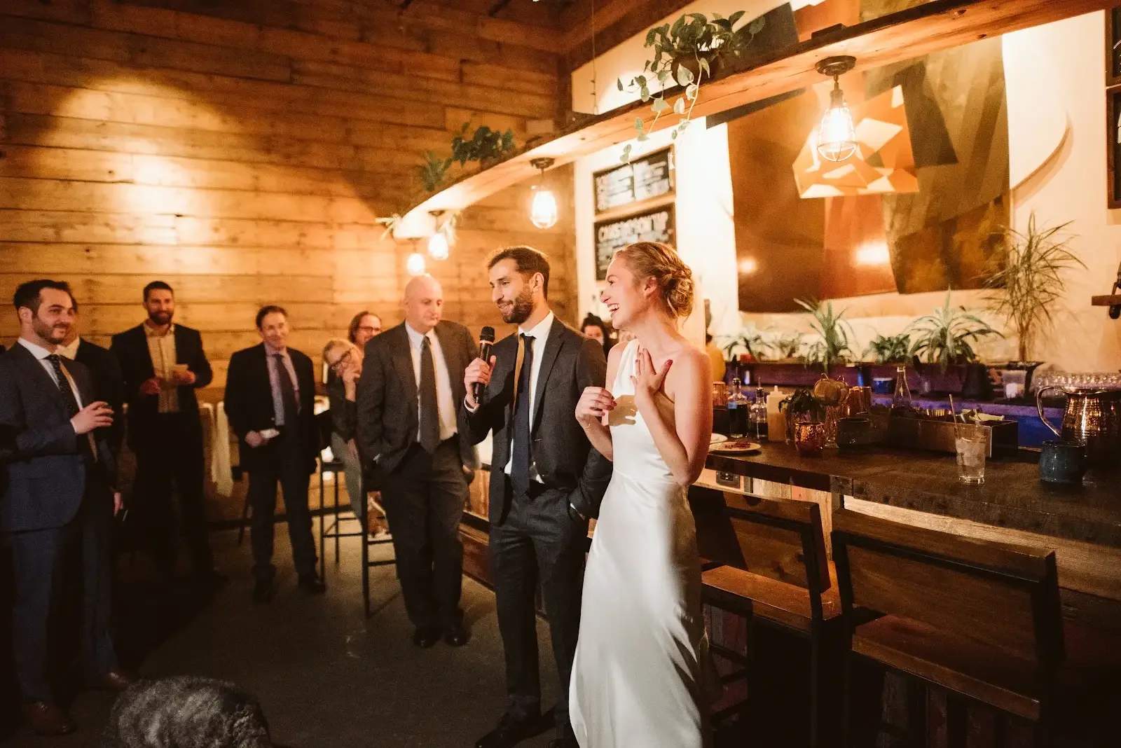 A couple celebrating their wedding in State Line’s wood-lined lounge