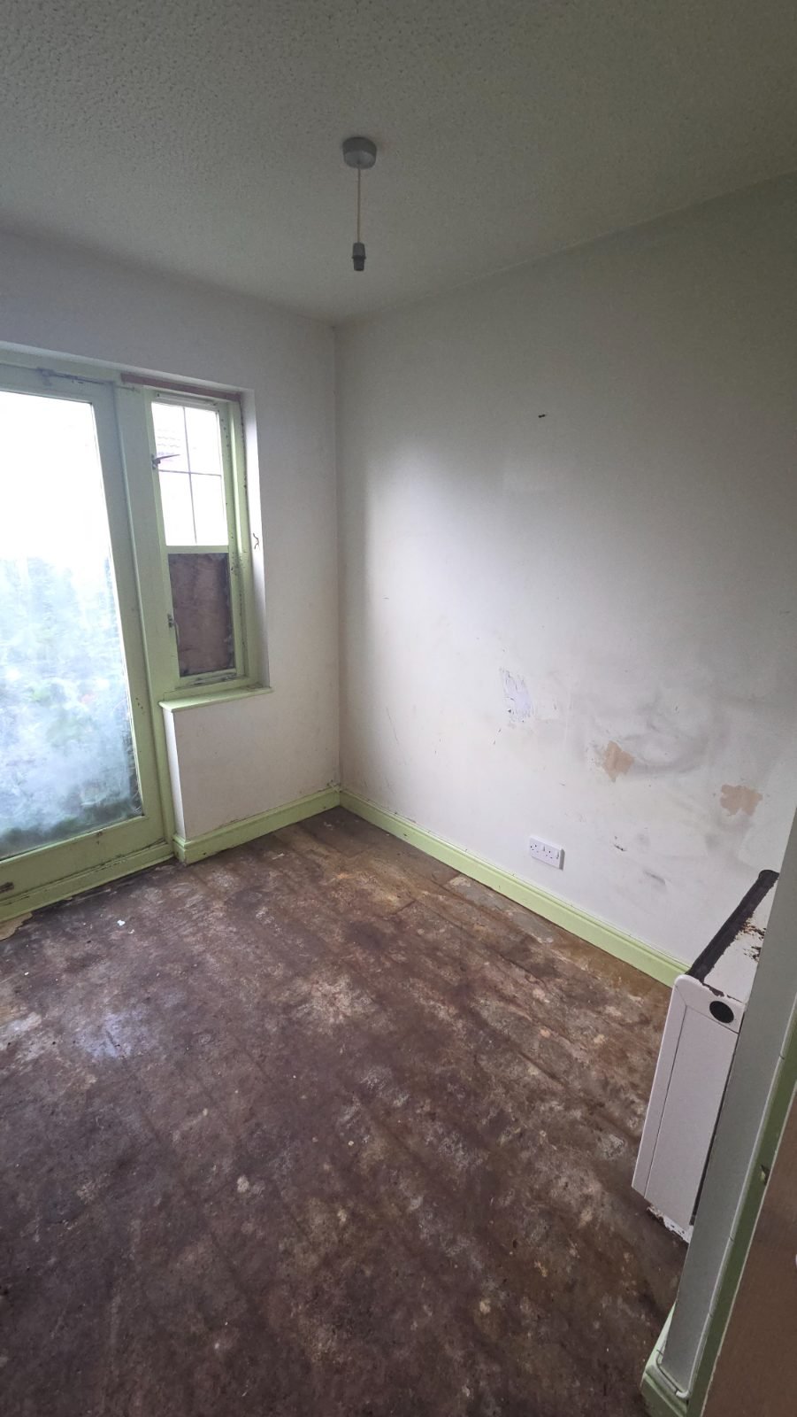 The same kitchen area after a full clearance, cleared to the floor and cleaned