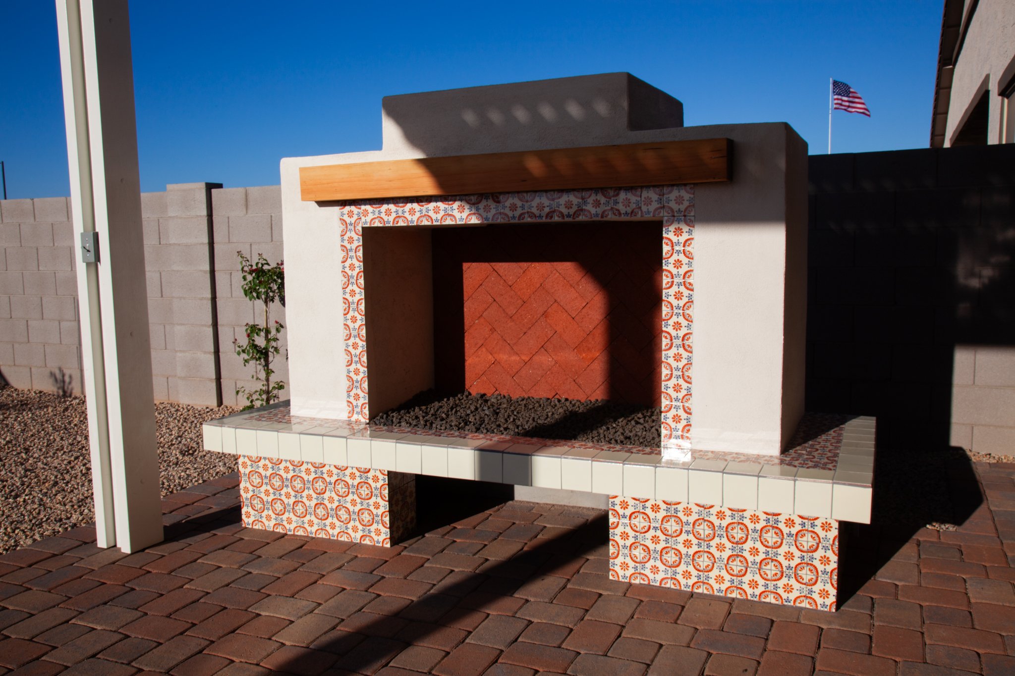 Modern patio design with built-in L-shaped seating and fire pit
