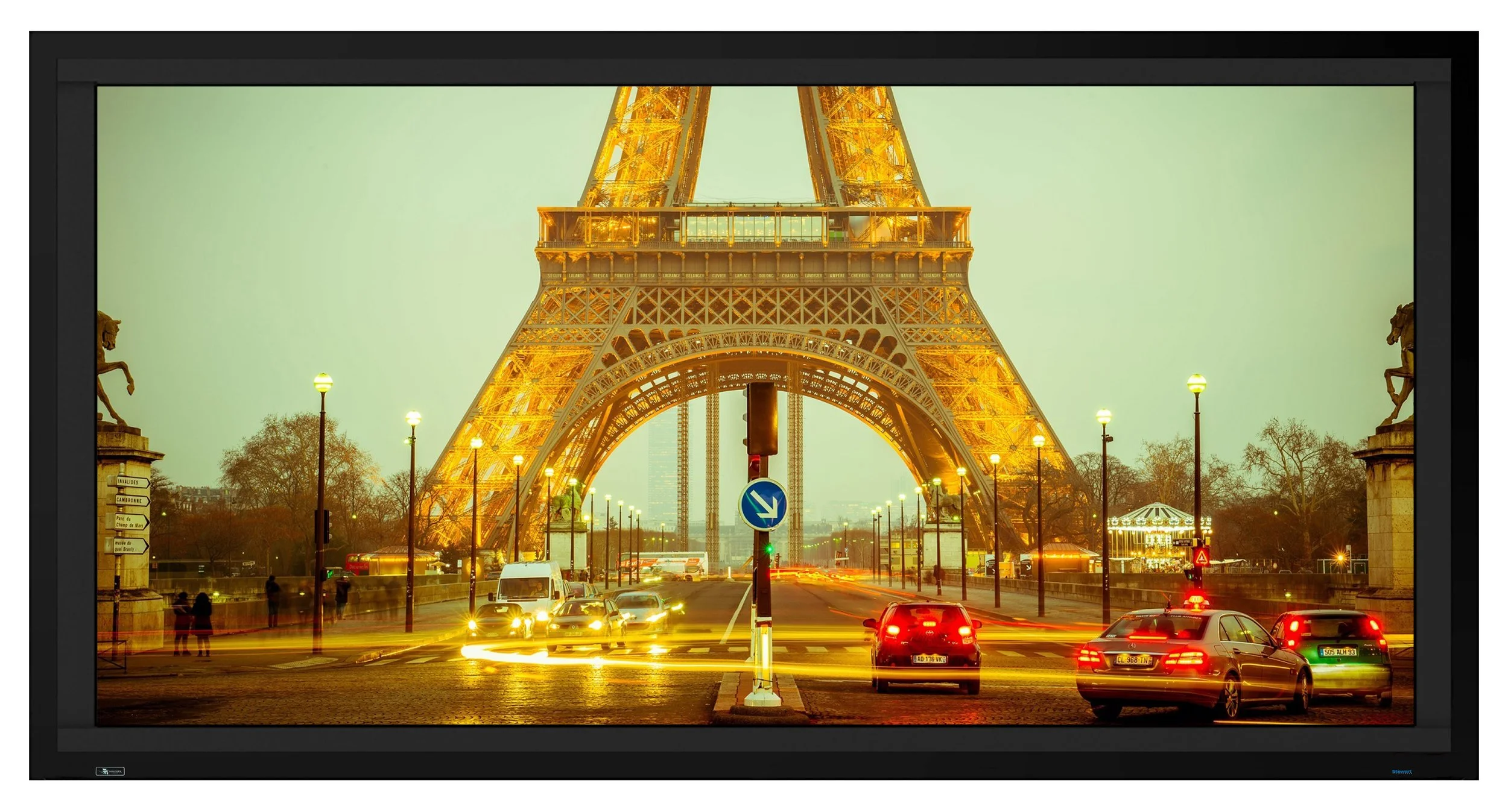 Stewart Filmscreen Director's Choice EVO screen displaying a night city scene with bright light sources against dark surroundings