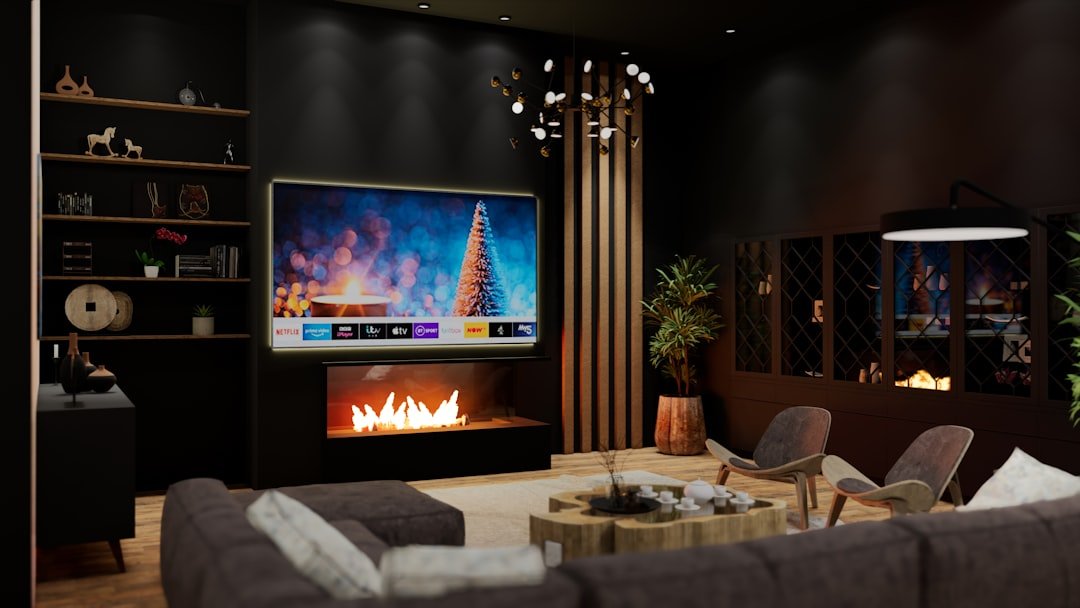 Luxury living room with a Crestron Home controlled display above the fireplace by VIP Smart Homes Seattle