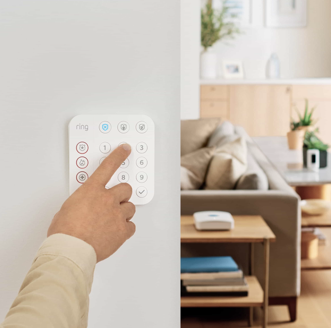 Person Arming Ring Alarm System Using Wall Mounted Ring Keypad in Modern Living Room | VIP Smart Homes