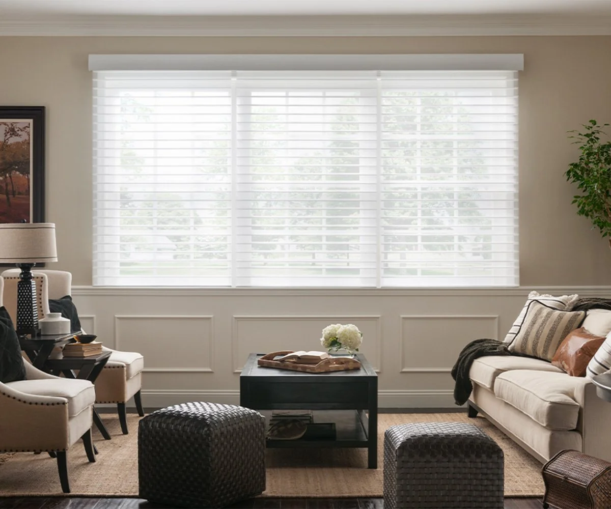 Lutron horizontal sheer blinds with white fabric vanes in elegant living room with three large windows and traditional decor