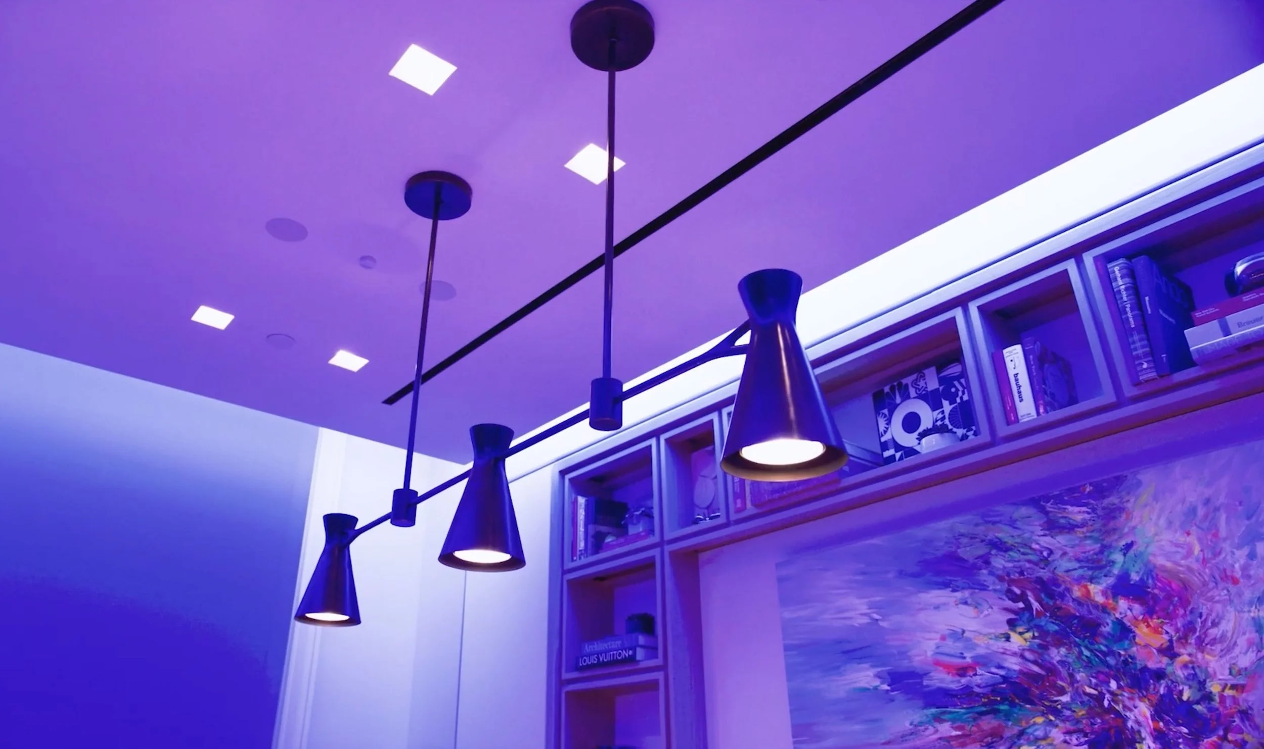 Lutron HomeWorks Color Tunable Downlights Casting Vivid Purple Scene Demonstrating Programmed Lighting Control in Modern Living Space | VIP Smart Homes