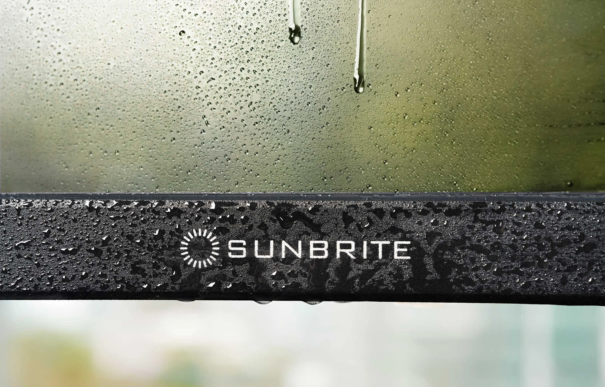 Close-up of SunBrite outdoor TV bezel with water droplets demonstrating weatherproof IP55 construction VIP Smart Homes Seattle