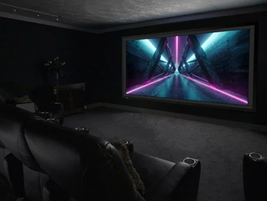 Home theater with wall sconces on and a Stewart Filmscreen Director's Choice EVO screen holding contrast with lights up | VIP Smart Homes Bellevue