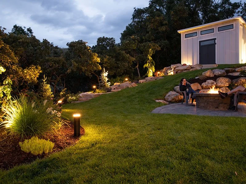 Episode outdoor audio system integrated into covered patio with television, fireplace, and pool deck | VIP Smart Homes Seattle