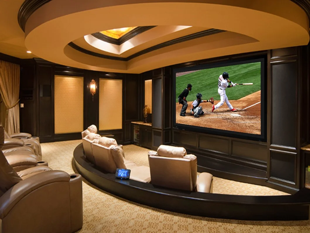 Luxury private cinema with tiered seating and a Stewart Filmscreen Director's Choice EVO masking screen displaying a live sports broadcast | VIP Smart Homes Bellevue