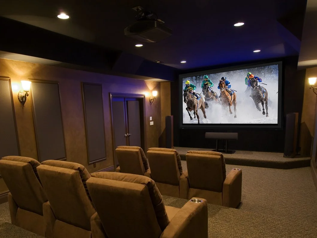 Dark dedicated home cinema with a Stewart Filmscreen Director's Choice EVO screen and surround speakers positioned around the seating | VIP Smart Homes Seattle